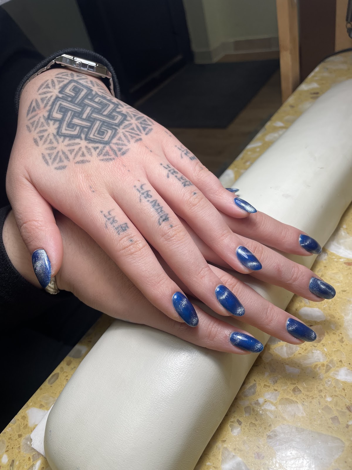 Finished manicure with blue glittery nail polish at Beauty Nail Salon